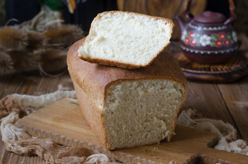 Milk bread on the yeast at home in red form on the board