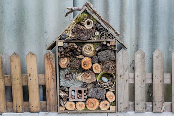  Handmade Bee Hotel made from recycled 
 second materials at hand. a makeshift insect hotel