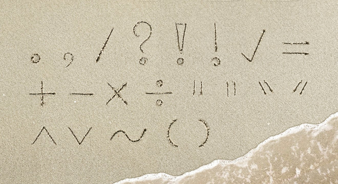 Punctuation mark handwritten in the sand on the beach