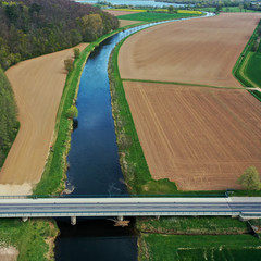 Aerial view of a traffic bridge with asphalt raod over the river Leine in Germany