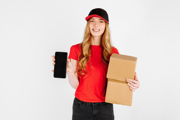 Courier , holding cardboard boxes and showing a blank mobile phone screen for a copy of the space on a white background