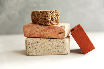 Pieces of different natural stones on a light background, eco concept, different texture, gravity, Natural mineral