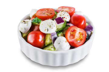 Tomato cucumber red onion mozzarella salad on a white isolated background