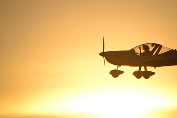 Fototapeta premium airplane at sunset flying, in air, pilot