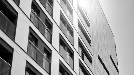 Detail of modern residential flat apartment building exterior. Fragment of new luxury house and home complex. Black and white.