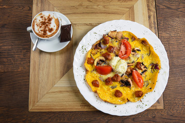 Omelet with sausages and vegetables