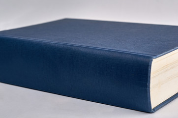 blue book on white background with copyspace