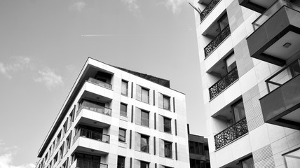 Detail of modern residential flat apartment building exterior. Fragment of new luxury house and home complex. Black and white.