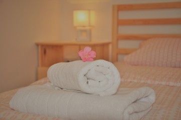 Rolled towel on the bed in the bedroom