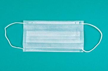 New medical mask on an azure background. Top view.