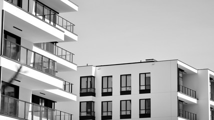 Detail of modern residential flat apartment building exterior. Fragment of new luxury house and home complex. Black and white.