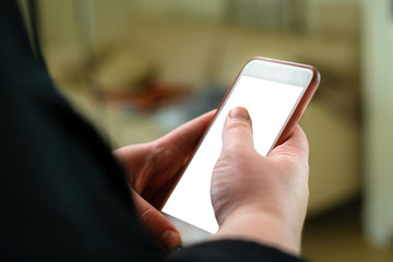 Close up of woman reading news on smart phone at home. Hands texting message or scrolling on social media. Browsing internet, chatting online