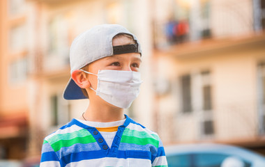 Fototapeta na wymiar Coronavirus quarantine. Boy in a surgical bandage. Coronavirus, illness, infection, quarantine, medical mask, COVID-19. Boy in a medical mask.
