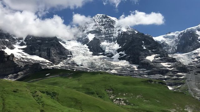 Mountain landscape in the alps.  View to Jungfrau from Mannlichen with Eiger and Monch  mountain (Swiss Alps) in the background, Berner Oberland, Grindelwald, Switzerland.