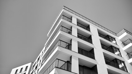 Detail of modern residential flat apartment building exterior. Fragment of new luxury house and home complex. Black and white.