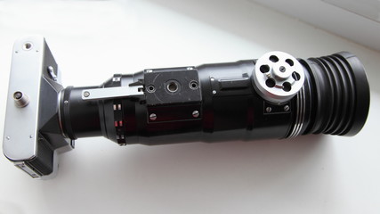 Retro Soviet Photo gun closeup bottom view - SLR film camera with large telephoto lens on white...