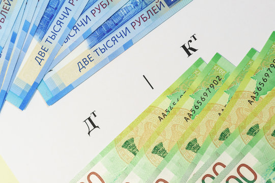Accounting is an orderly system for collecting, registering and documenting all business transactions. Russian text " Debit. Credit" , ruble bills