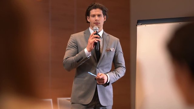 Young businessman having speech durnig conference