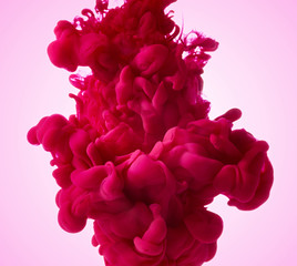 Color drop in water on pink background