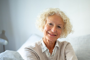 Fototapeta na wymiar Close up happy elderly woman relaxing at home