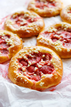 Yeast sweet rolls with the addition of strawberries and crumble, close up view. Traditional kolaches
