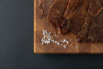 Close-up of a piece of meat on a wooden Board with spices. Restaurant menu, a series of photos of different dishes
