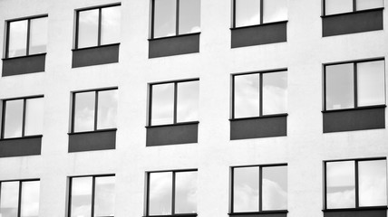 The windows of a modern building for offices. Business buildings architecture. Black and white.