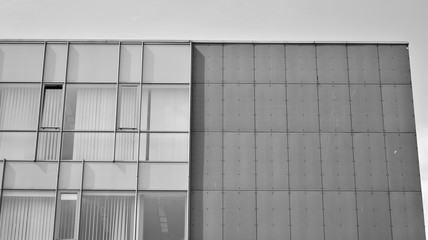 Fototapeta na wymiar The windows of a modern building for offices. Business buildings architecture. Black and white.
