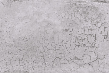 Texture of an old white wall with a lot of cracks