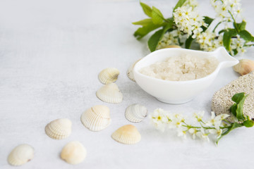 Concept of Spa-cosmetic and cosmetic procedures. Spa-sea salt in white dishes and seashells on...