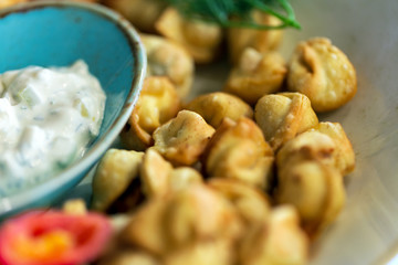 Dumplings, sour cream and fresh vegetables