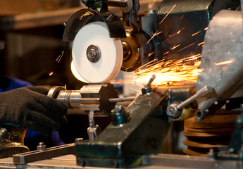 Grinding machine at work. Sparks.