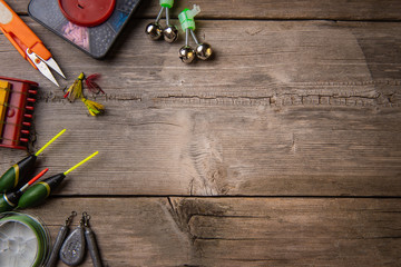 Background from fishing gear laid out on an old wooden table. flat lay. Fishing background. View...