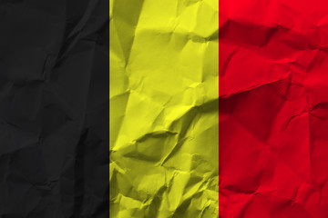 Belgium national flag on crumpled paper.