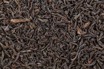 Dried Tea Leaves. The texture of large leaf black tea. Closeup.