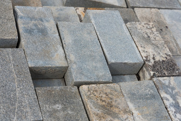 Marble, granite tiles are stacked in a row after use. Background, texture.