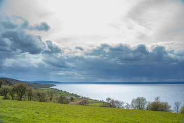 Horizontal Landscape of Small idyllic Rural Village Uppgranna By the Big Lake Vattern in Smaland, Sweden. Dramatic Weather in the Distance.