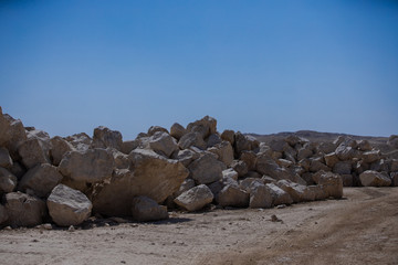 Limestones and testing hammer of geologists in limestone quarries