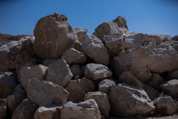 Limestones and testing hammer of geologists in limestone quarries
