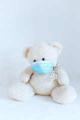 soft toy in a medical mask on a white background