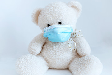 soft toy in a medical mask on a white background