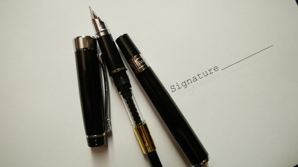Blank ink pen without ink near the signature of the document