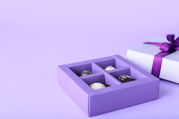 Box with delicious chocolate candies on white background
