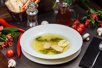 a white bowl filled with Delicious chicken noodle soup