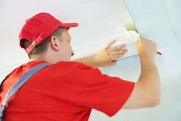 installing decorative ceiling molding. home repair and decoration © Kadmy