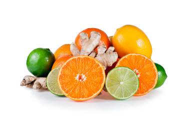 Orange fruits with tangerines, limes, lemons and ginger roots isolated on a white background.