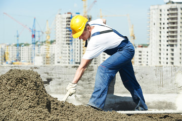 Roof construction. worker roofer leveling with float lute