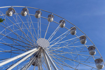 Empty ferris wheel with a blue sky in the background