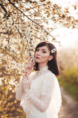 woman in white flowering trees