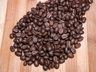 Organic black coffee beans on wooden table